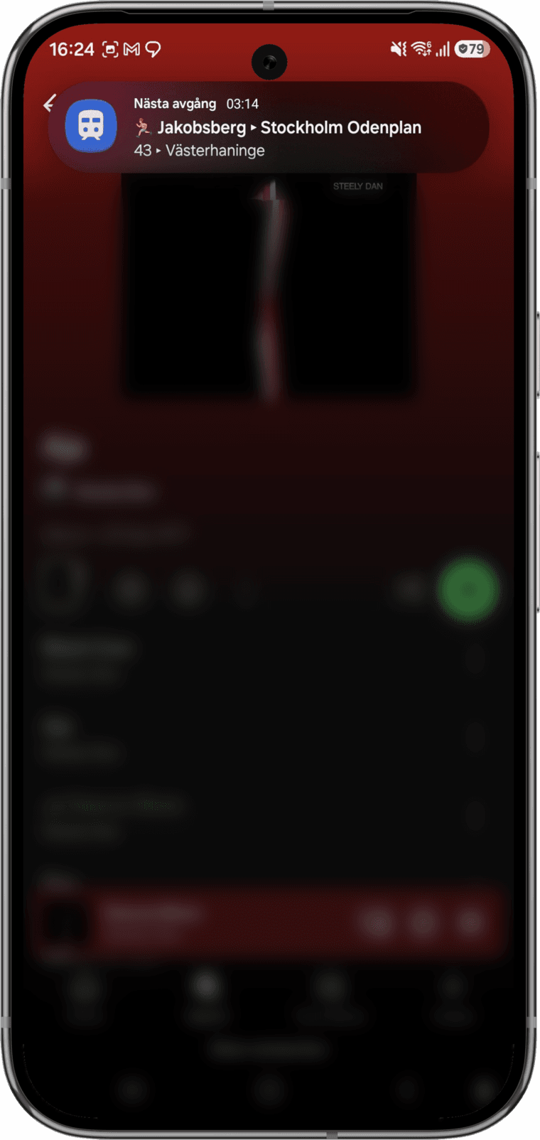 The live departure notification, floating over another app
