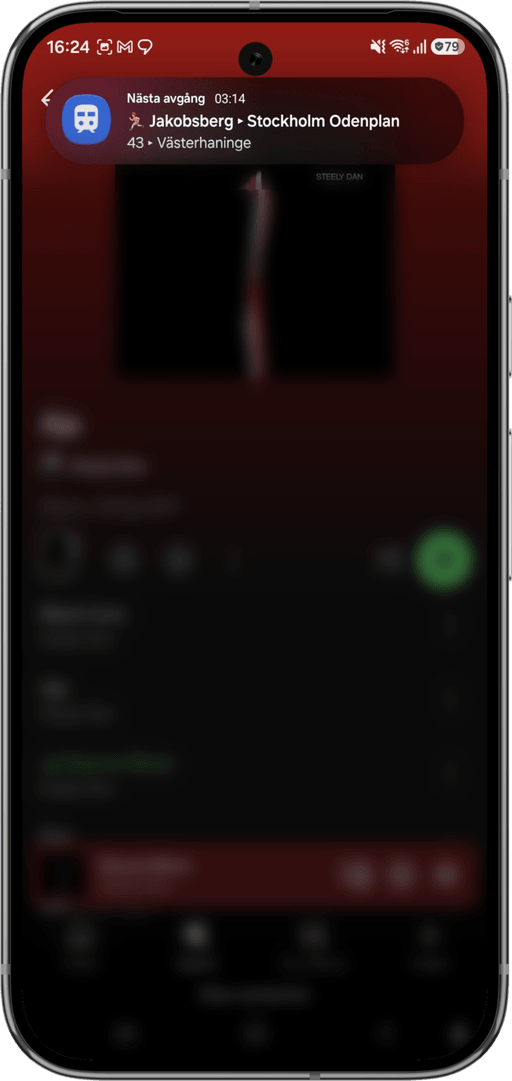 The live departure notification, floating over another app